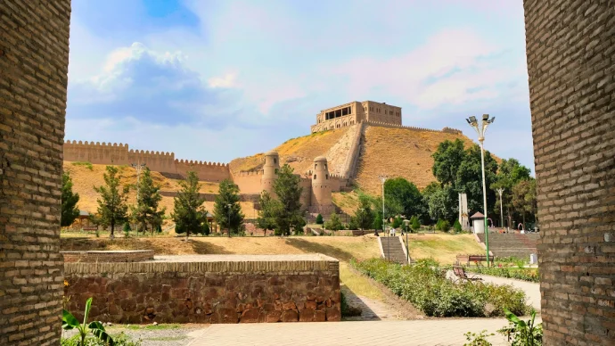 a view of a castle through two brick walls