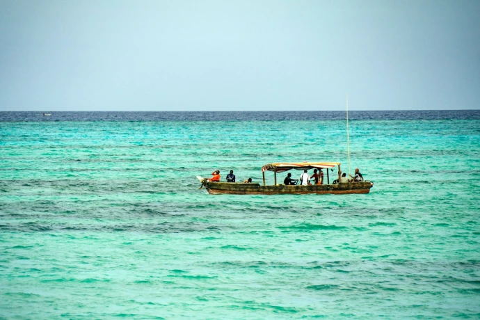 group of people riding on the boat surrounded by body of water