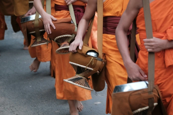 A group of monks walking down a street